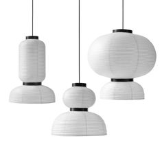 three white lanterns hanging from the ceiling in front of a white background with black accents