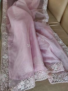 This is a fascinating pure organza silk saree in gorgeous light pink color. Saree features a dazzling beads and pearl work embroidery of floral design throughout the edges of the saree. Simple pearl work is twinkling all over the body of the saree. The beads and pearl embroidery are delicately hand embellished. Organza is a lightweight plain weave fabric. The pure organza attributes to a very comfy and flowy drape. Organza is considered as one of the most stylish and glamorous wear. This is a gr Pearl Work Embroidery, Embroidery Blouse Saree, Cutdana Work, Pearl Embroidery, Organza Silk Saree, Saree Designs Party Wear, Simple Pearl, Belly Dancer, Embroidered Blouse Designs