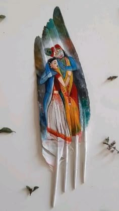 a plastic fork with an image of a man and woman painted on it's side