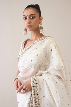 Pearl white saree with scattered metal beads and sequin embroidery. Paired with an embroidered unstitched blouse piece. - Aza Fashions Wedding Embellished Chanderi Blouse Piece, White Chanderi Pre-draped Saree For Celebration, Transitional Season Embellished Wedding Blouse, Elegant White Pre-draped Saree For Eid, Elegant Festive Blouse In Kundan, Embellished Tissue Silk Blouse For Weddings, Elegant Embellished Saree For Transitional Season, Embellished Blouse For Wedding And Eid, Elegant Embellished Transitional Saree