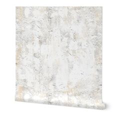 an abstract white and gold wallpaper with metallic foil on the bottom, in front of a