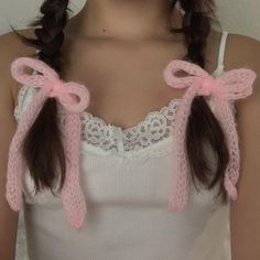 a woman wearing pink knitted hair ties