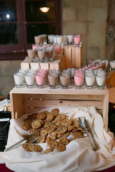 there are many desserts on the table with spoons and cups next to them