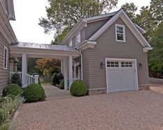 a gray house with white trim and two car garages