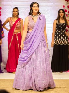 Embrace elegance and grace with the Samantha Lehenga. Crafted with intricate mirror, pearl, and stone embroidery work, this whimsical lehenga exudes a sense of grandeur, making it perfect for special events and occasions. Key Features: Precious mirror, pearl, and stone embroidery work Lavender color exuding beauty and grace Soft net fabric for a gorgeous and elegant look Elevate your style with the Samantha Lehenga, designed to bring out your innate grace and elegance. The silk blouse adorned wi Samantha Lehenga, Buy Lehenga Online, Intricate Mirror, Indian Bridal Couture, Elegant Veils, Reception Gowns, Stone Embroidery, Mehendi Outfits, Bridal Lehenga Red