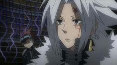 an anime character with white hair and black eyes standing next to another character in front of a stage