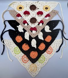 four crocheted triangulars are arranged on top of each other