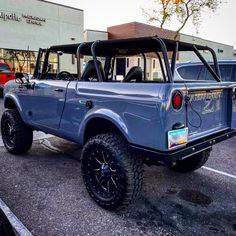 a blue truck parked in front of a building