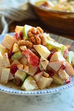 a plate filled with fruit and nuts on top of a table