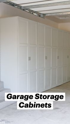 an empty garage with white cabinets and stairs