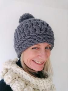 a woman wearing a knitted hat and scarf