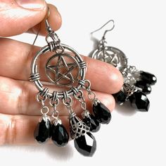 These handmade earrings make a great gift. Silver pentagram with black faceted glass beads. Finished with your choice of silver plated or sterling silver ear wire. Please keep in mind these are heavy earrings.  Product details 3 inches long by 1 inch wide Pentagram charm is silver plated silver plated or sterling silver ear wire black faceted glass beads Please keep in mind these are heavy earrings.   VISIT MY SHOPS HERE   * http://www.etsy.com/shop/HappyCatHouse * http://www.Etsy.com/shop/AnEnc Black Dangle Witchy Jewelry, Black Metal Witchy Earrings, Witchy Black Nickel-free Earrings, Witchy Black Dangle Jewelry, Black Witchy Dangle Jewelry, Black Wire Wrapped Metal Earrings, Black Nickel-free Dangle Chandelier Earrings, Nickel-free Black Metal Chandelier Earrings, Goth Things