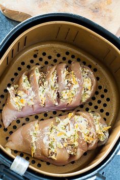 two pieces of meat sitting in an air fryer