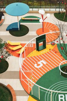 an aerial view of a playground with colorful play equipment