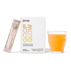 an orange drink next to a box of goop good morning skin superpowder