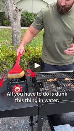 a man is cooking on the grill with a red spatula in his left hand