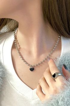 Get ready to rock the glam punk vibes with our Heartbreaker Necklace. This statement piece features a thick 4mm ball chain that exudes edgy style. The centerpiece is a heart charm, painted in monochrome for a bold and eye-catching look. The combination of the chunky chain and the punk-inspired heart charm creates a perfect blend of retro and contemporary aesthetics. - Chain: approx. 17", Nickel-free Alloy- Charm: approx. 12mm (0.47"), Nickel-free Alloy, Epoxy Trendy Metal Heart Beads Necklace, Trendy Black Metal Heart Necklace, Trendy Metal Heart Necklace, Trendy Metal Heart Necklace With Heart Beads, Trendy Silver Heart Necklace, Emo Style Necklaces As Gifts, Punk Black Necklace With Heart Pendant, Punk Black Heart Pendant Necklace, Black Punk Heart Pendant Necklace