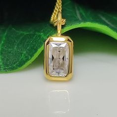 This elegant pendant features a 1.67-carat radiant-cut moissanite solitaire, showcasing its brilliant sparkle. The gemstone is bezel-set in 14k yellow gold, offering a secure and sleek design. This minimalist piece combines timeless charm with contemporary simplicity, making it a perfect accessory for women seeking a classic yet modern look. Bezel Set Moissanite Pendant 1.67 CT Radiant Cut Moissanite Solitaire Classic Pendant, 14k Yellow Gold Charm Minimalist Pendant For Womens Moissanite Pendan White Rectangular Jewelry With Single Diamond, White Rectangular Moissanite Jewelry, Rectangular White Moissanite Jewelry, Rectangular Moissanite Jewelry As A Gift, Square Cut Moissanite Jewelry For Gifts, Rectangular Yellow Gold Moissanite Jewelry, Rectangular Gold Moissanite Jewelry, Rectangular Moissanite Gold Jewelry, Minimalist Pendant