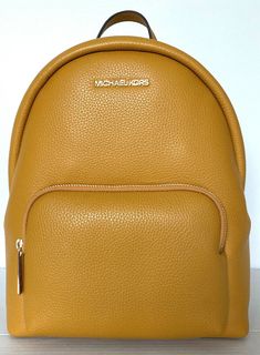 New with tags 100% Authentic Michael Kors  Erin Medium Backpack Marigold with Gold tone hardware Style # 35FOGERB2L The Erin backpack promises both style and function in a streamlined, easy-to-wear shape that’s designed for any lifestyle. Pebbled leather construction offers luxe texture, while the spacious interior will effortlessly stow everything from a tablet to a pair of flats. Pebble Leather 26"-30" adjustable shoulder straps Interior details: iPad compartment, back zip pocket and front sli Medium Backpack, Girly Shoes, Easy Trendy Outfits, Handbags Michael Kors, Types Of Fashion Styles, Interior Details, Pebbled Leather, Leather Backpack, Shoulder Straps