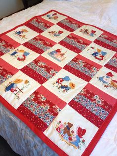 a red and white quilt on top of a bed