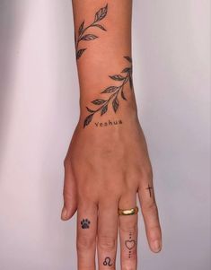 a woman's hand with tattoos on it and the word yashu written in cursive writing