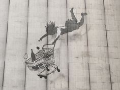 graffiti on the side of a building with a person in a mask and a shopping cart