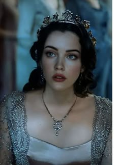 a woman wearing a tiara and dress in a scene from the movie snow white