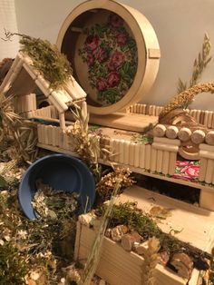 an assortment of miniature houses and other items on top of a shelf in a room