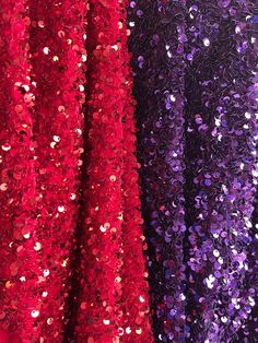 two different colored sequins sitting on top of a red and purple table cloth