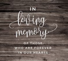 a wooden background with the words in loving memory