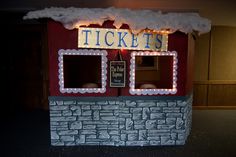 a fake ticket booth with lights on the roof and windows in front of it that says tickets