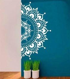 the wall decal is decorated with an intricate flower design in white on a teal blue background