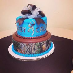 a blue and brown camouflage cake on a table