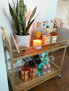 a bar cart filled with liquor bottles and glasses