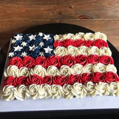 an american flag cake with red, white and blue frosting on it's side