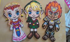 three pixelated characters are displayed on a piece of paper