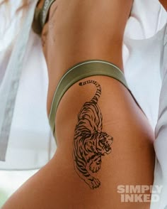 a woman with a tiger tattoo on her thigh