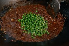 peas are being cooked in a pan on the stove