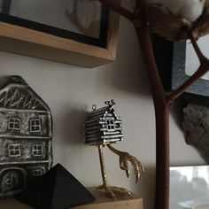 there is a tree that has been placed on the shelf next to some other items