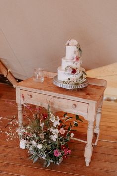 a table with a cake and flowers on it