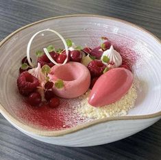 a white bowl filled with food on top of a wooden table