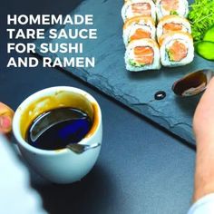 sushi and ramen are being served on a slate platter