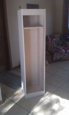 a wooden cabinet sitting in the middle of a living room