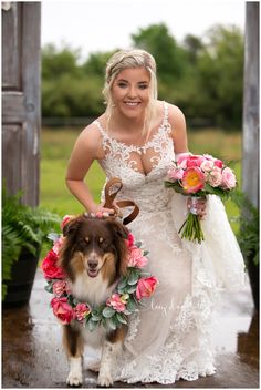 a woman in a wedding dress standing next to a dog with flowers around her neck