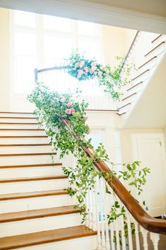 some plants are growing up the side of a stair case in front of a window