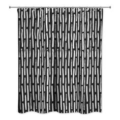 a black and white shower curtain hanging on a metal rod with an abstract design in the middle