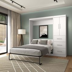 a bedroom with blue walls and white furniture