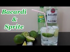 a bottle of bacardi and some limes on a table next to it