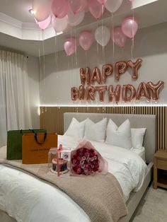 a bedroom decorated with balloons and gifts for the birthday girl on her bed is shown