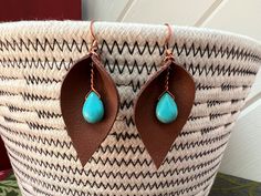 a basket with some brown and blue earrings on it